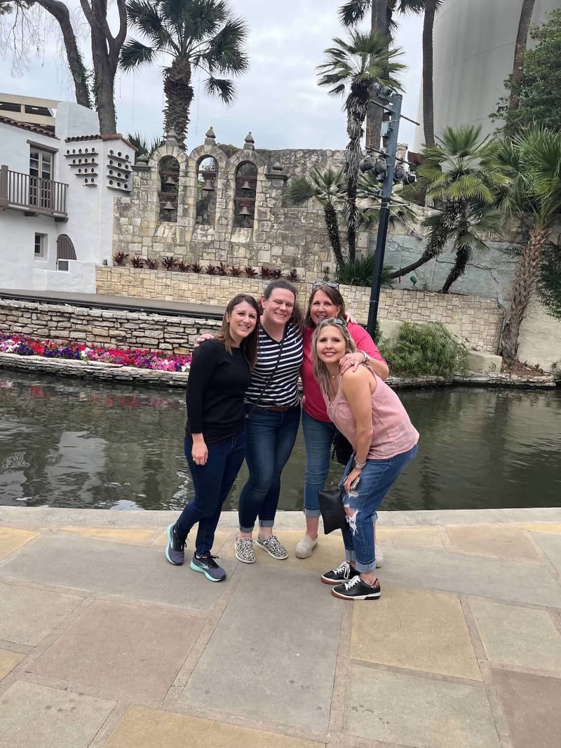 Four women posing on the San Antonio Riverwalk