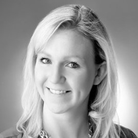 A black and white photo of a woman with long hair smiling.